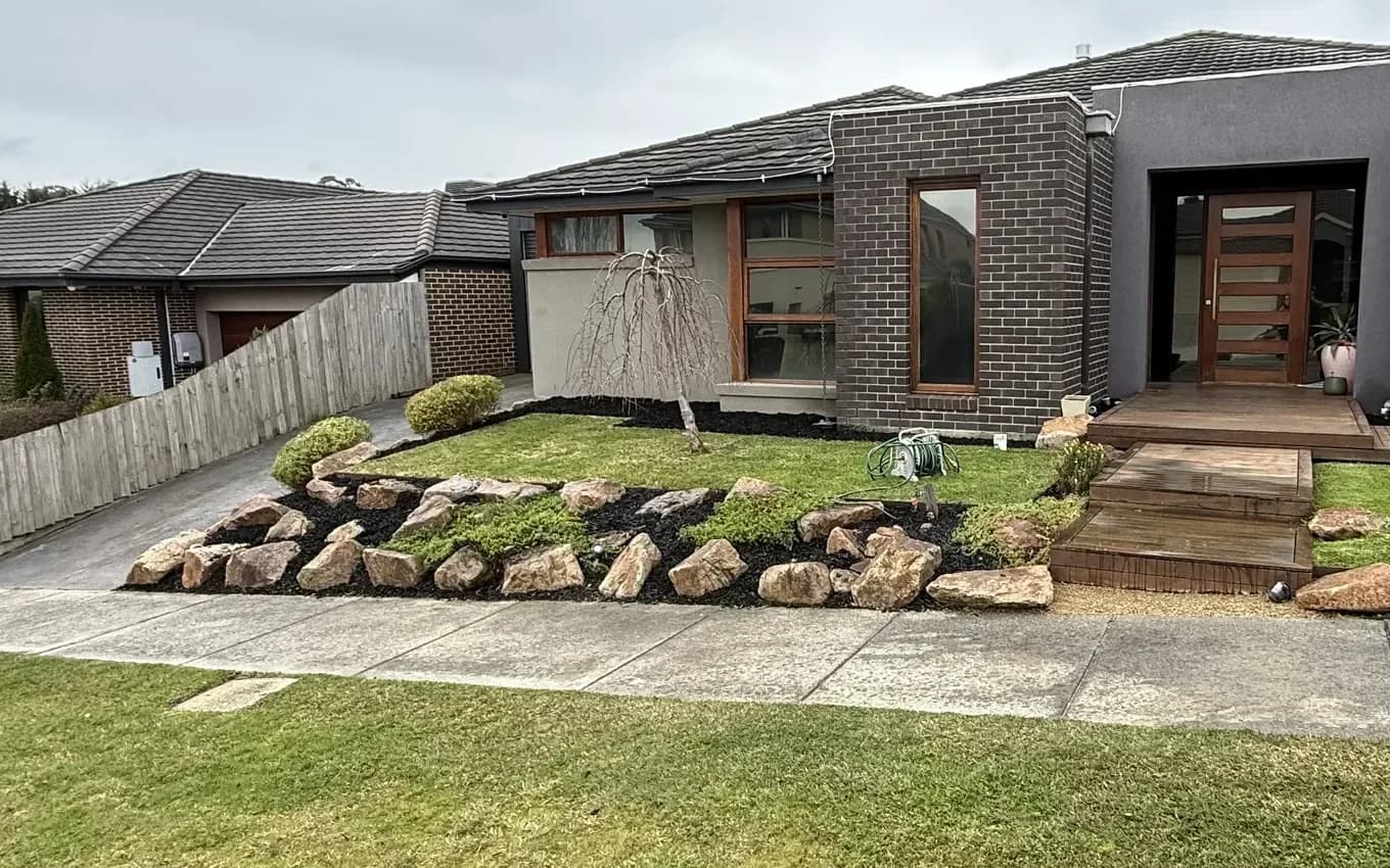 Tidy front garden with rock border, fresh mulch and clipped lawn